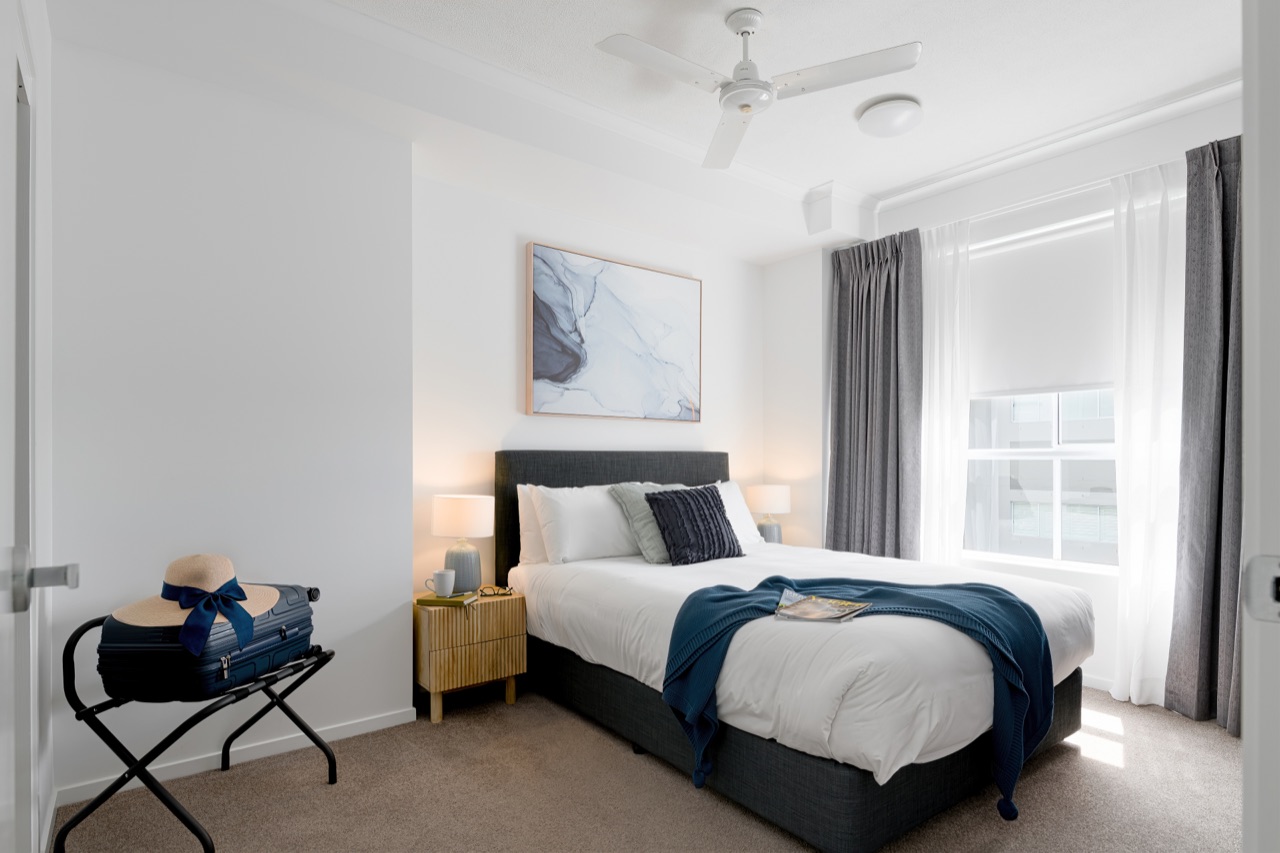 Penthouse master bedroom with queen bed and contemporary styling