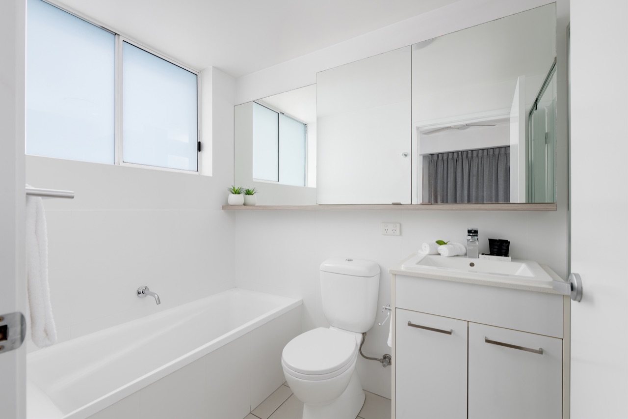 Ensuite bathroom with a full bathtub and vanity